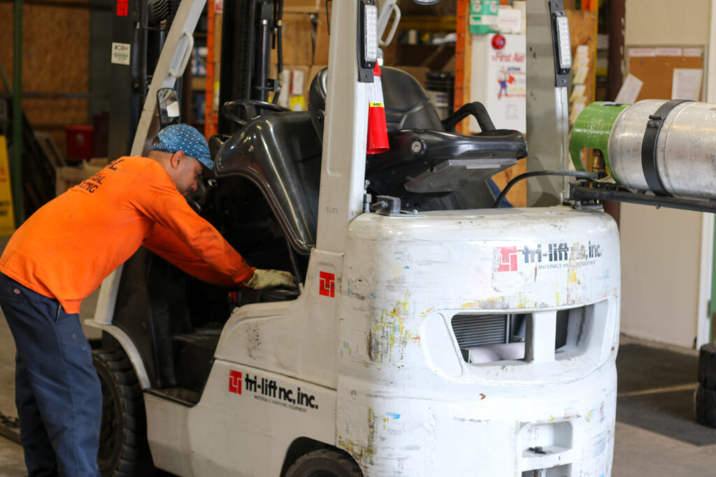 Forklift service, man working on a forklift
