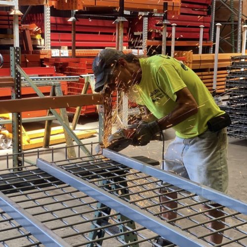 Warehouse worker cutting wire racking material