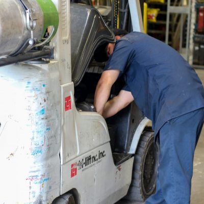 Forklift service, Man working on forklift