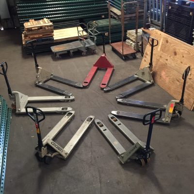 pallet jacks in a circle Various pallet jacks arranged in a circle in a warehouse with other material handling equipment.